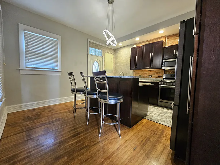 The white door in the picture leads to a personal roomy fenced in backyard.