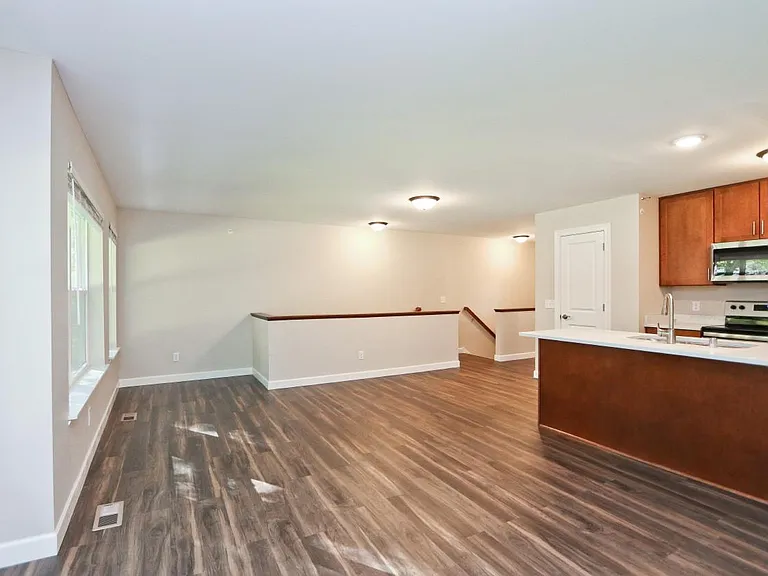 Open floor plan with breakfast bar seating at counter