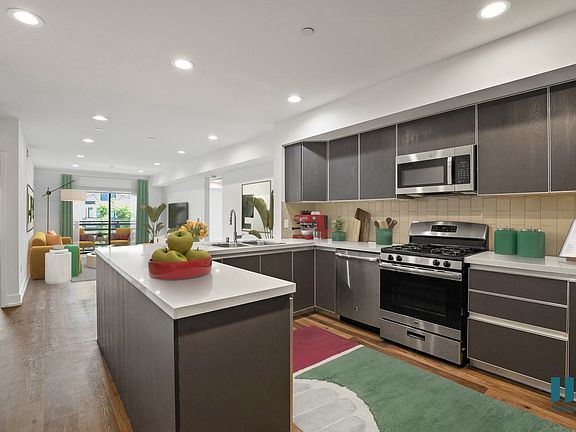 Open-Concept Kitchen, Dining, and Living Room with a Patio