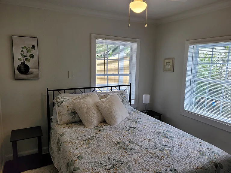 This back bedroom has a closet and a smart TV on the wall. Queen bed.