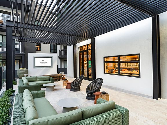 Shaded courtyard lounge at Modera Higley Commons, offering a polished place to gather just moments from Gilbert's dining, retail, and entertainment.