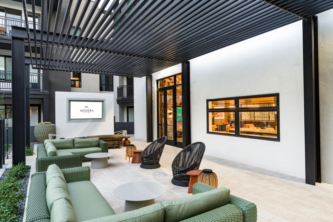 Shaded courtyard lounge at Modera Higley Commons, offering a polished place to gather just moments from Gilbert's dining, retail, and entertainment.