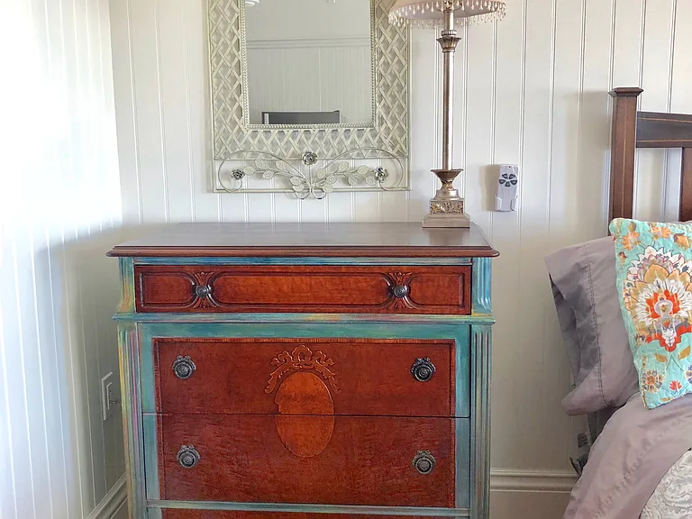 Gorgeous artistic antique dresser with four drawers provides space for your clothing.