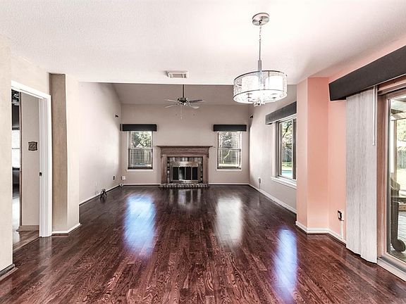 Gather the family and guests together in your lovely living room! Featuring soaring high ceilings, ceiling fan, gorgeous floors, stunning fireplace, and large windows that provide plenty of natural lighting throughout the day!