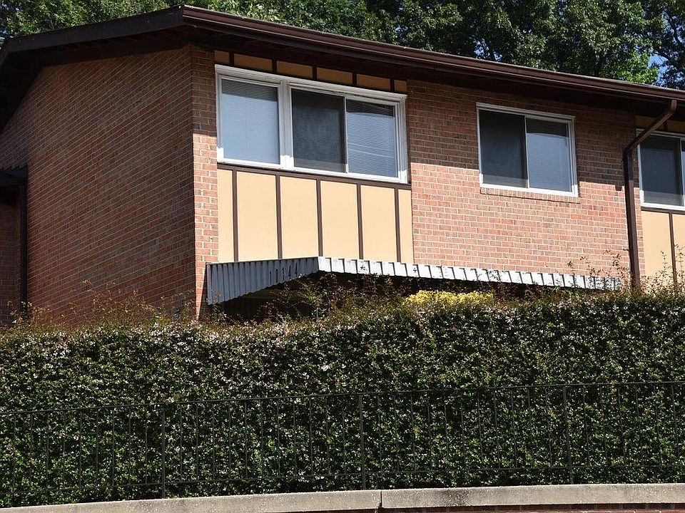 View of town-style condo from parking lot. Hedge offers a nice touch of privacy to relax on the porch
