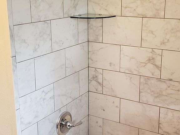 Brand new plumbing and tile surround in the baths!