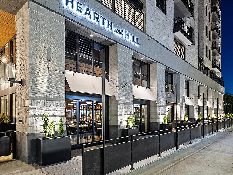 Wider view of Hearth and Hill's patio at dusk