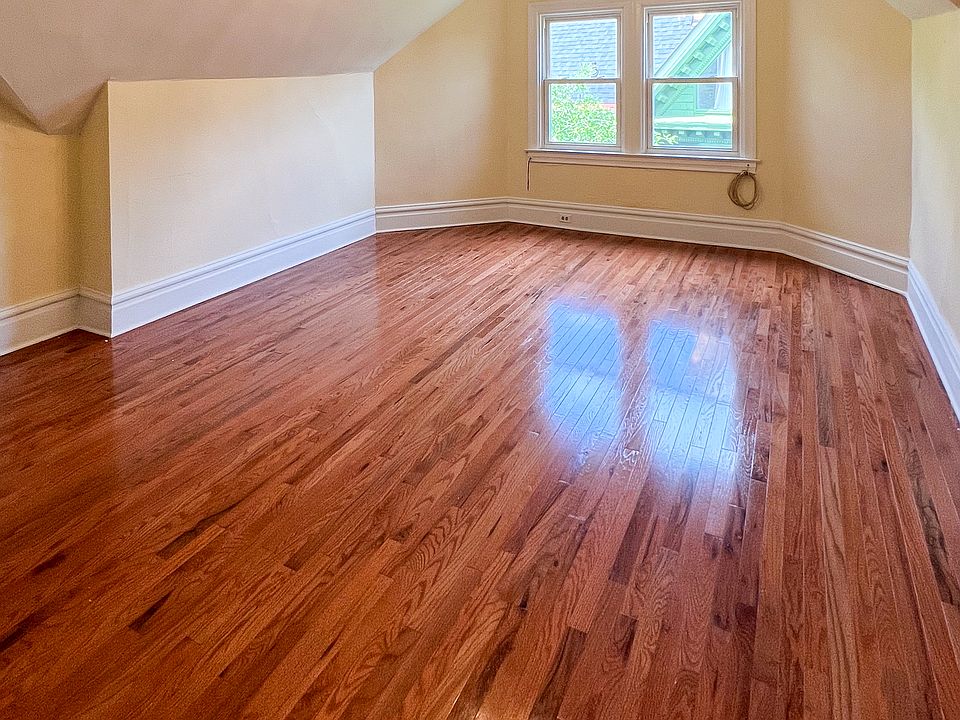 Empty room with professionally refinished hardwood flooring