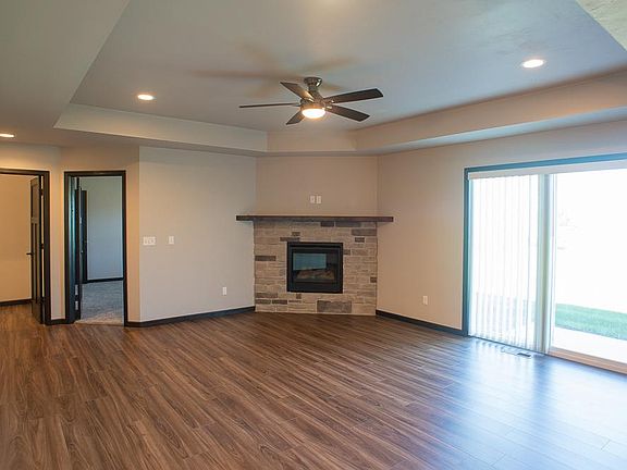 Spacious living room with gas fireplace and patio window to backyard.
