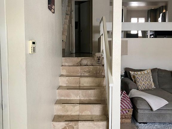 stairs to half guest bath, dinning and kitchen