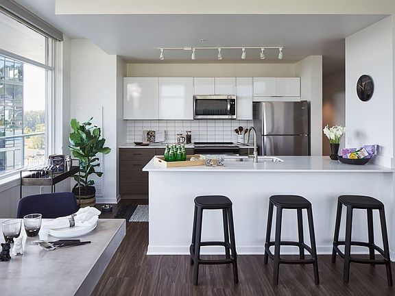 Large kitchen with attached island and stainless steel appliances