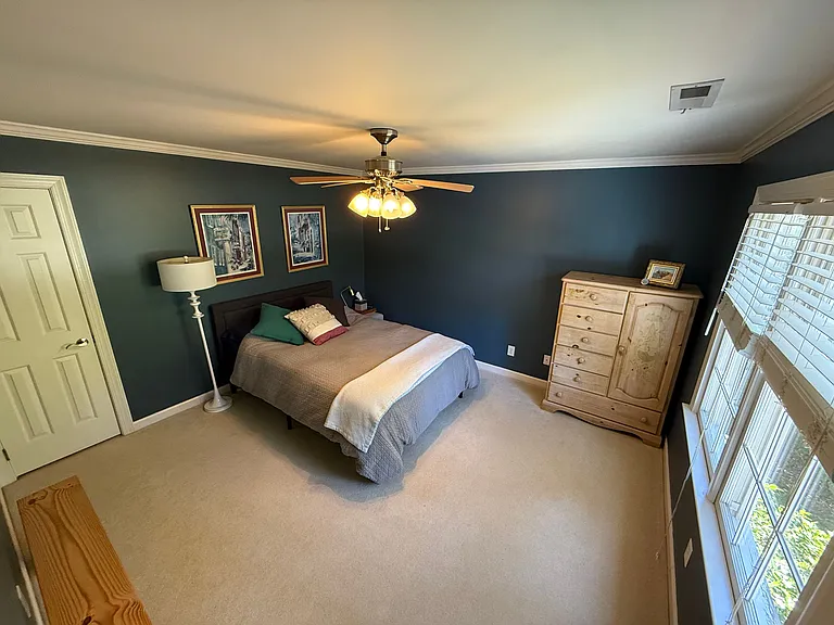 Guest bedroom (closet on left; views of front yard on right)