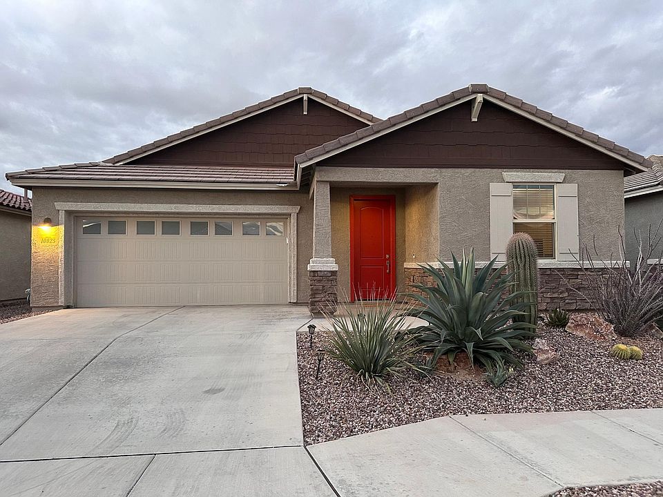 2 car garage and desert landscaping greets you