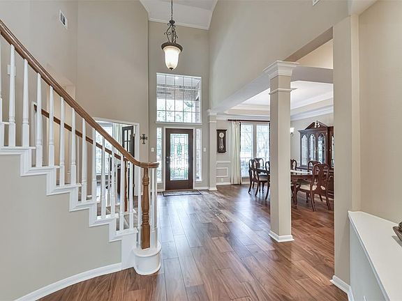 The foyer features an open passage way to the formal dining
