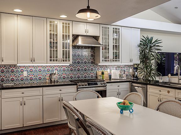 The kitchen looks out on the yard and deck for indoor outdoor entertaining