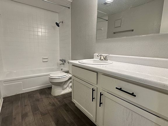 Spacious Bathroom with White Cabinetry and Large Mirror