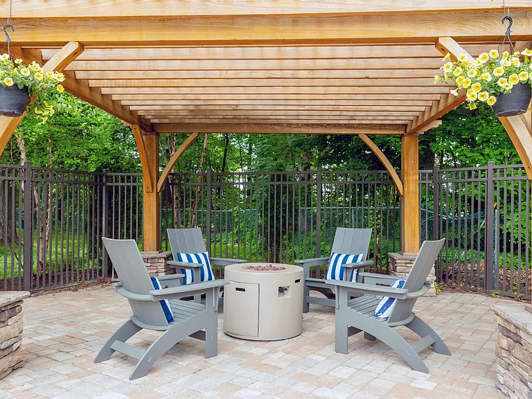 Experience warmth by the pool at our fireside chill zone, complete with a stylish pergola offering protection from the elements and relaxing Adirondack seating.
