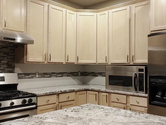 Kitchen with latest granite countertop and lots of cabinets