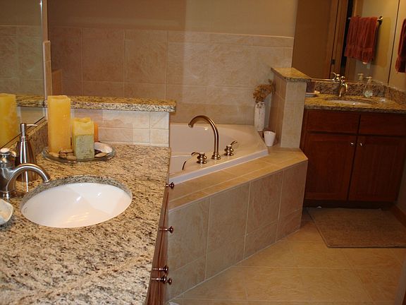 The master bath has ceramic tile floors and granite countertops.