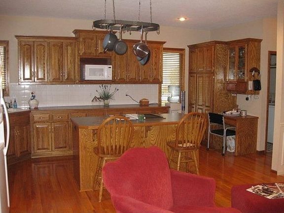 Kitchen w/pot rack above island, built in desk & tons of cabinets & counters!