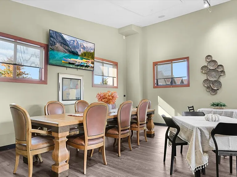 Community gathering room with games, cozy seating, and large dining table for a variety of engageing events.