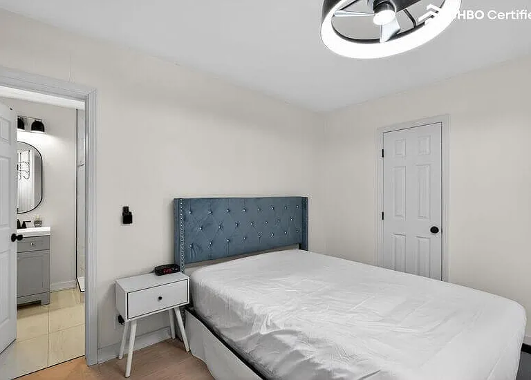 A spacious, serene retreat featuring a plush queen