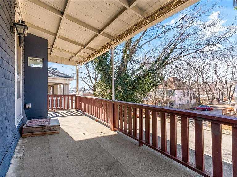 First private balcony just off the kitchen overlooking the front yard.