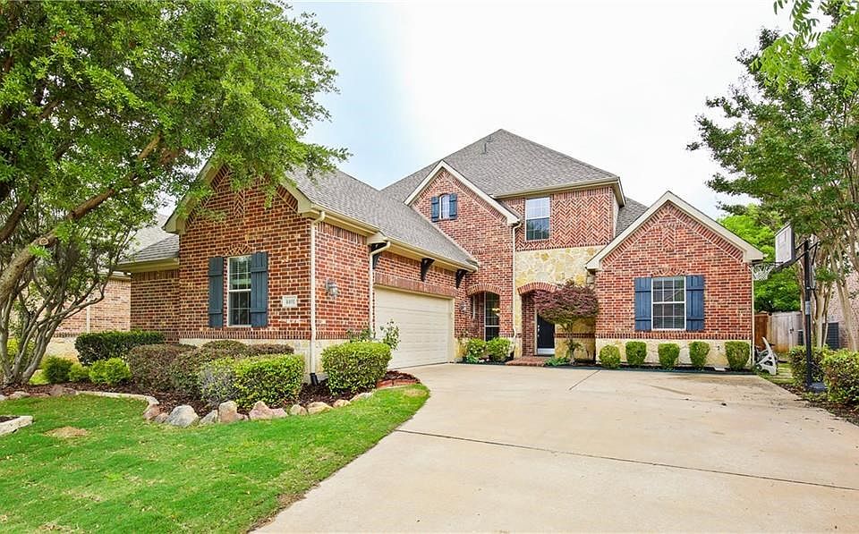 Amazing Brick & Stone elevation coupled with lush landscaping creates stunning curb appeal!