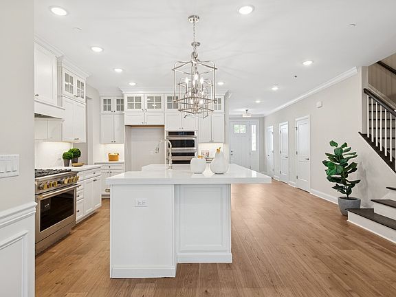 Kitchen with stacked glass-front upper cabinets