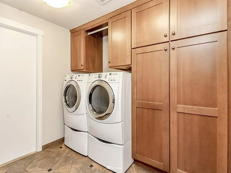 floor to ceiling storage in laundry room. Door on left leads to garage, Bathroom to the right