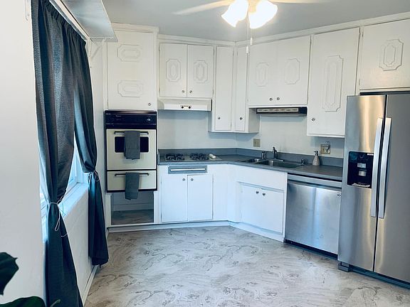 Kitchen. Lots of cabinet space/storage, stove & oven, new stainless steel dishwasher, new stainless steel refrigerator, new ceiling fan, and new flooring.