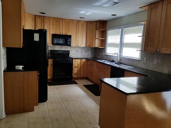 Kitchen, gas stove, granite countertops, travertine tile, an