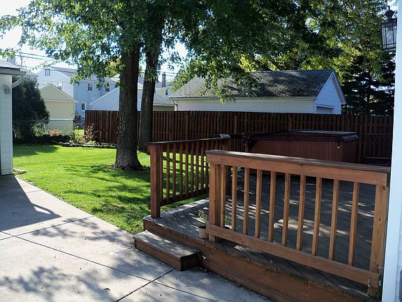 Privacy stockade fenced in yard with iron gate