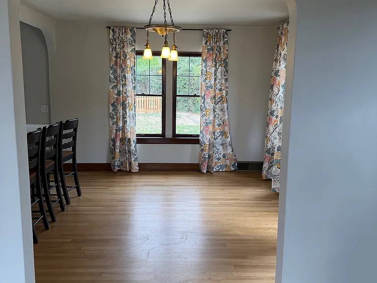 Looking from the living room to the dining room through original arches