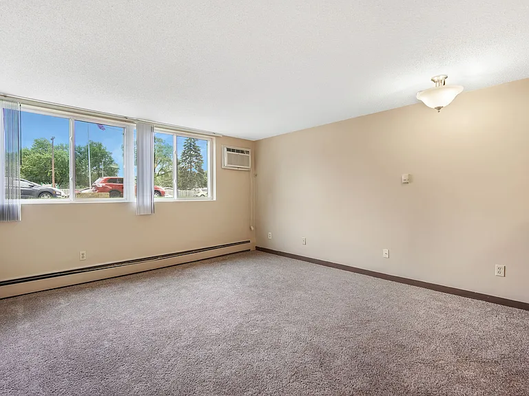 Living room with wall unit air conditioning