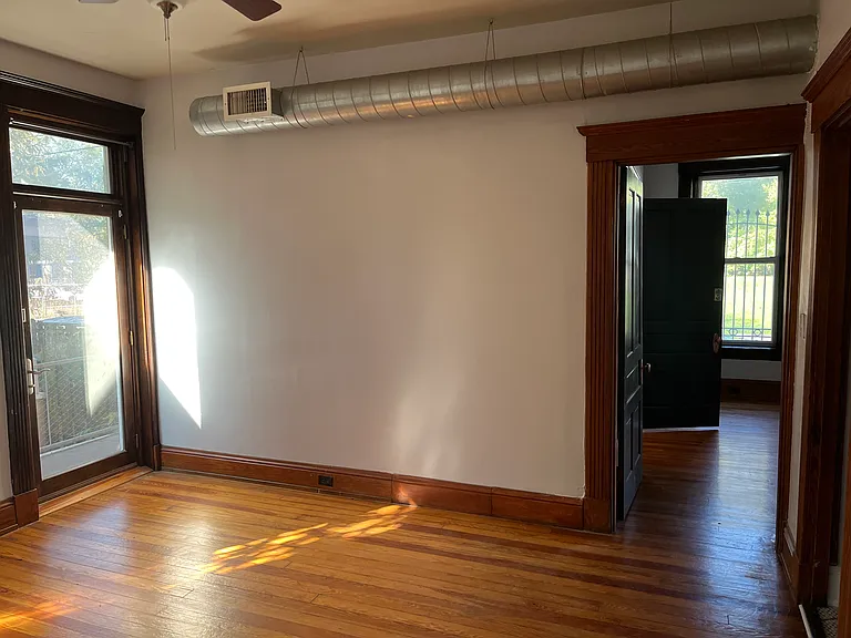 Bedroom with a view of the door to the balcony on the left.