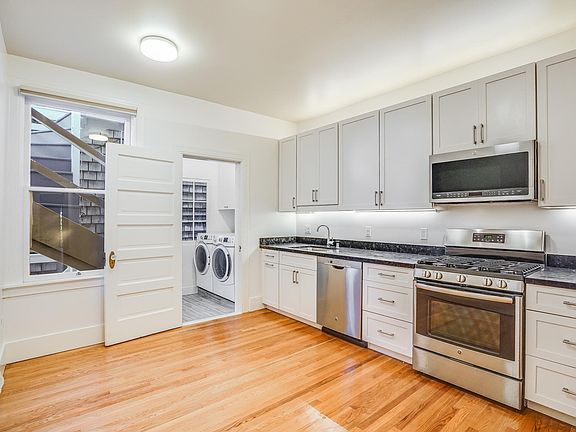 Renovated kitchen with dishwasher, gas stove, microwave, garbage disposal and attached, private laundry room.