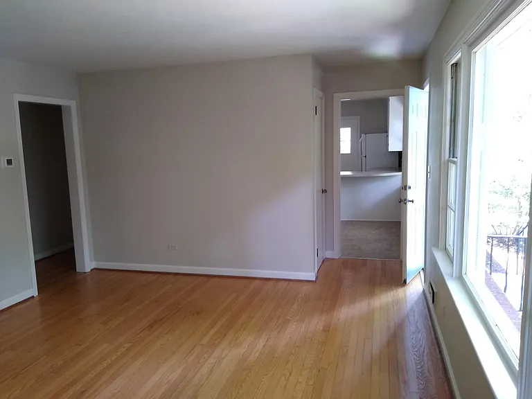 View from living room showing closet and door to dining room/kitchen