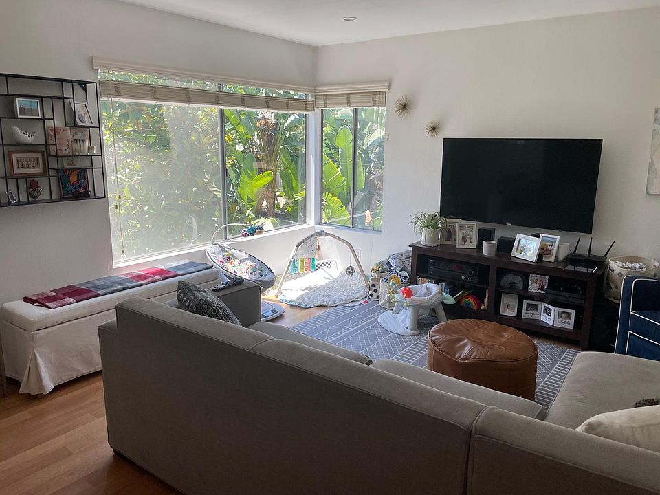 Light and bright living room with view of beautiful greenery!