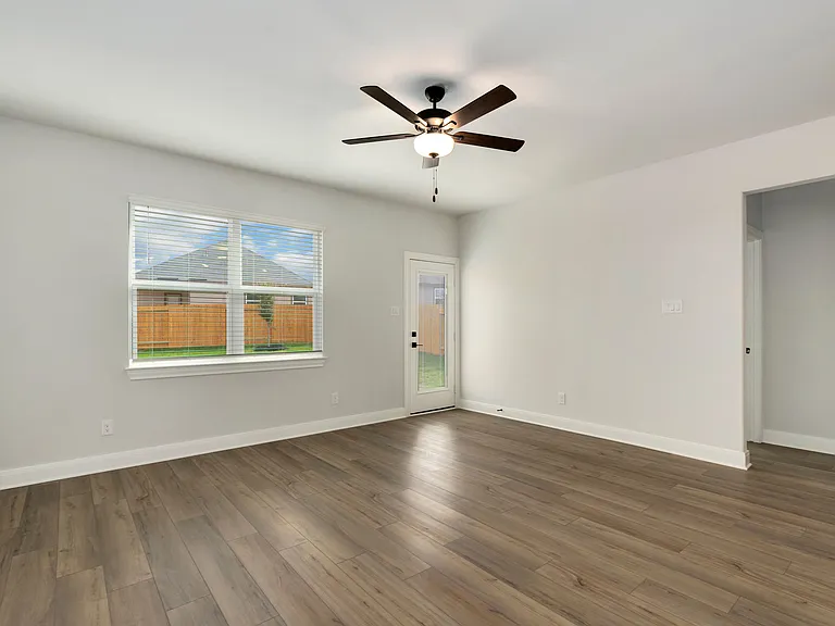 Window in the family room features a view of the backyard.