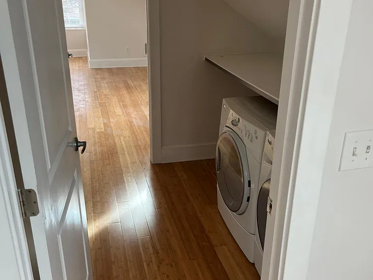 Laundry room with full size side by side washer dryer and folding shelf