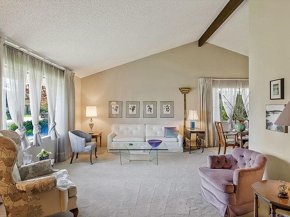 A beamed cathedral ceiling adds to the spacious feeling in the inviting living room...