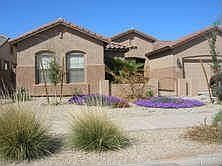 Elegant landscaping and a courtyard entrance sets this home apart.