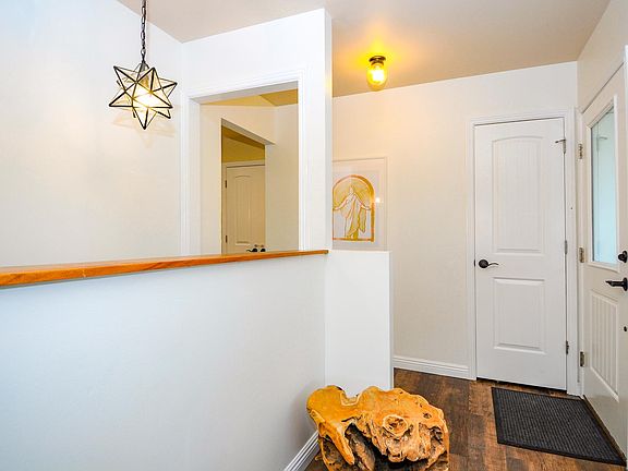 Front door, stairs to basement - view from living room
