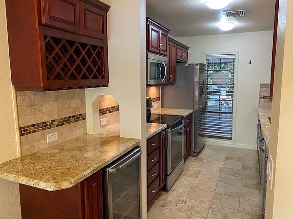 Beautiful Kitchen with granite countertops, Cherrywood cabinetry, stainless appliances, a 'wine bar' with wine fridge.