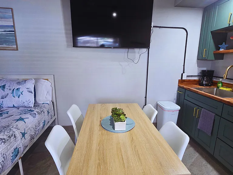Charming dining area with elegant decor and a Smart TV to unwind.