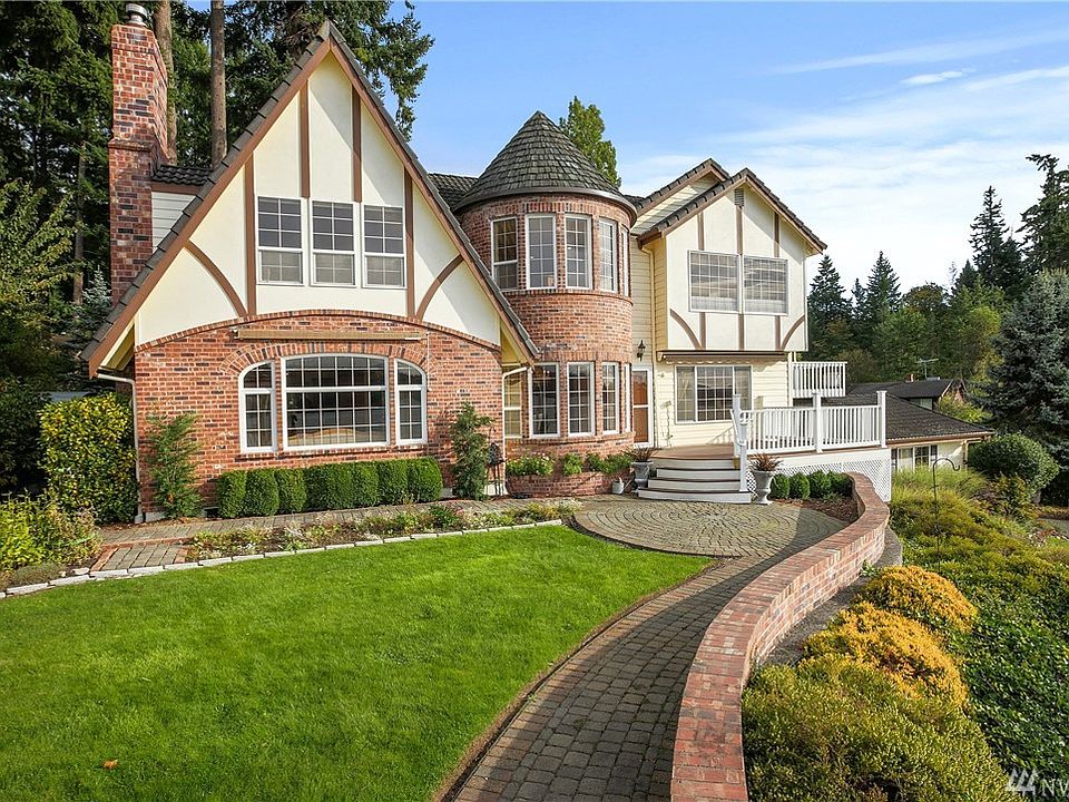 Stunning Tudor Brick Home on over an acre with 156 ft. waterfront across Beach Drive, which includes tidelands. The home is 2798 sq. ft. and is a two-story with finished basement.