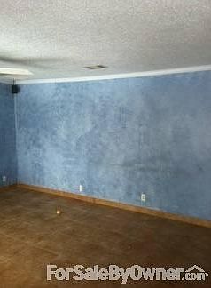 Living room
						:
						Ceramic tile floor, crown molding, faux marble paint, ceiling fan, coat closet.