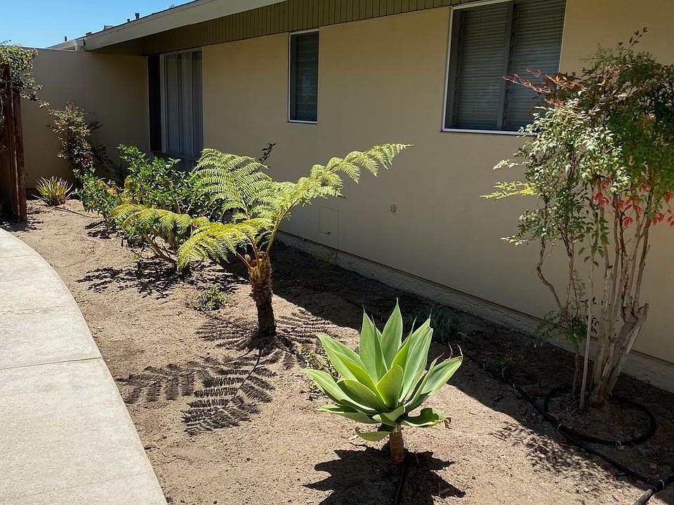 Walk up to the front door enjoying the beautiful landscaping.