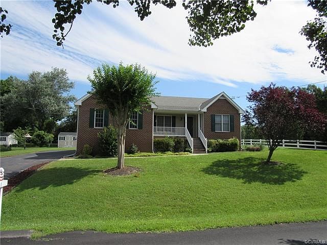 Brick front rancher with lavish landscaping and front porch